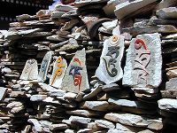 Close-up of prayer stones from the prayer stone wall next to Thanggyel Temple.